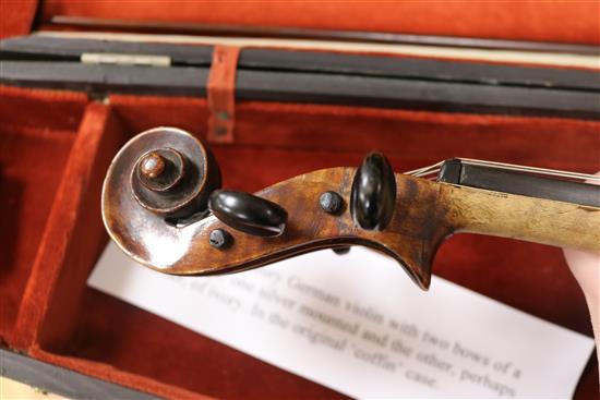 A silver mounted violin bow, an ivory mounted violin bow and a late 19th century German violin, cased